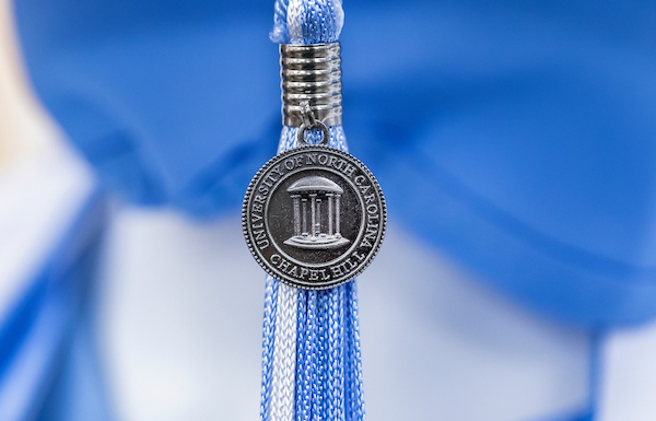 blue and white graduation tassel with university of north carolina seal