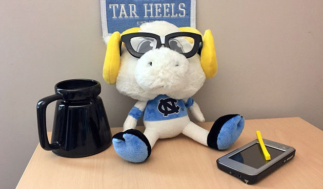 rameses in glasses with big mug and tech device